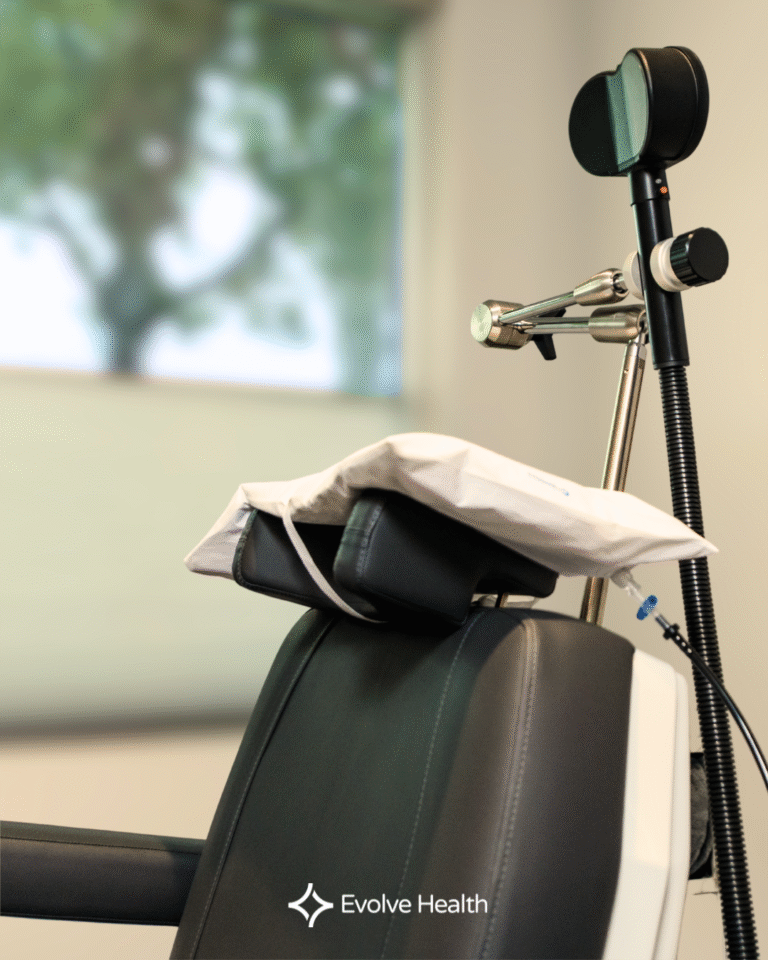 Tms treatment chair in focus against a slightly blurry white wall and outside window.